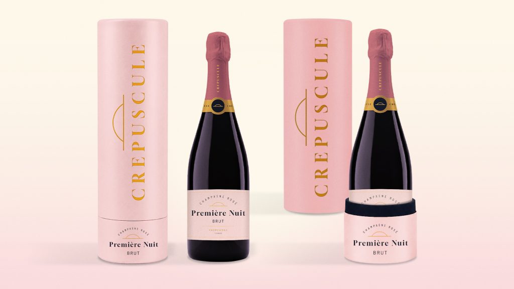 Packaging de coffret champagne luxe rose poudré avec bouteille Première Nuit et coffret cylindrique premium personnalisé